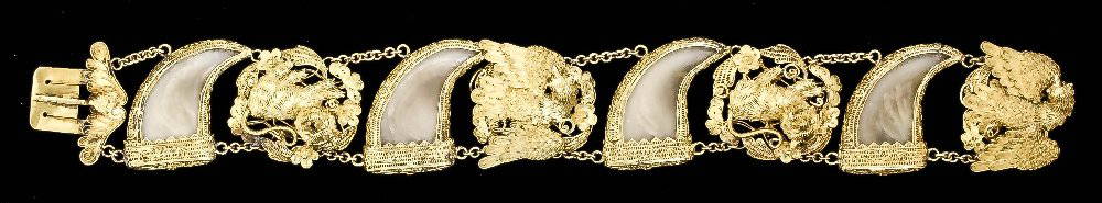 Chinese 18ct gold mounted tiger claw pattern bracelet, : Chinese 18ct gold mounted tiger claw pattern bracelet, the four tigers claws in filigree mounts with alternate panels of eagles and lions, 180mm x 23mm overall (gross weight 30.6 grammes - marked to r
