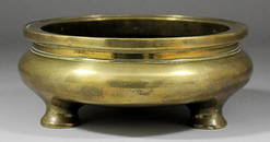 A Chinese bronze censer of circular squat form on three