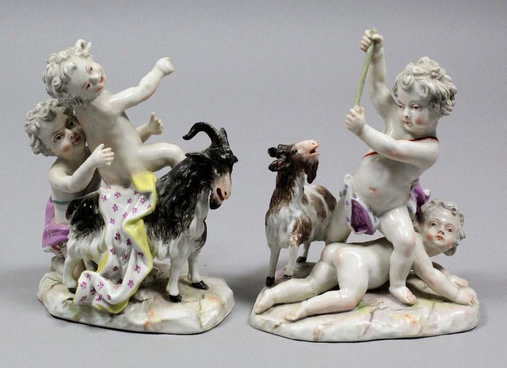 A pair of 20th Century Continental porcelain figures in: A pair of 20th Century Continental porcelain figures in the Meissen manner, of gambling putti with goats, 5.5ins high (crossed swords mark in underglaze blue to base - chipped)