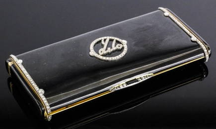 An 1920's Cartier gold coloured metal, black enamel and