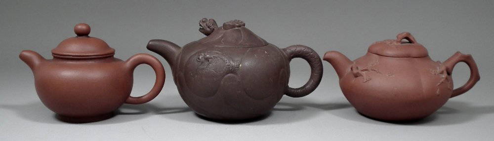A Chinese Yixing pottery teapot, 4ins (101mm) high, and: A Chinese Yixing pottery teapot, 4ins (101mm) high, and two others (all 20th Century)