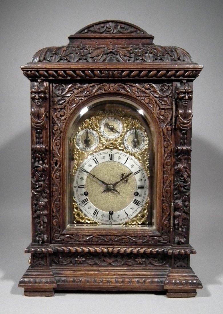 A late 19th Century German oak cased mantel clock by Wi: A late 19th Century German oak cased mantel clock by Winterhalter & Hofmeier, the 7ins arched brass dial with silvered chapter ring with Roman numerals and three regulation dials to arch to the eight 