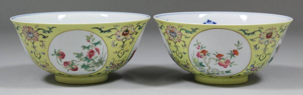 A pair of Chinese porcelain Famille Rose medallion bowl: A pair of "Famille Rose" porcelain medallion bowls, enamelled in colours with various flowers within circular medallions on a yellow sgraffito ground, the interior painted in underglaze blue with