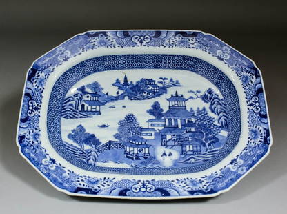 A Chinese blue and white porcelain octagonal meat plate: A Chinese blue and white porcelain octagonal meat plate, decorated with a landscape of pavilions beside water, 14.5ins (368mm) x 10.75ins (273mm) (20th Century)