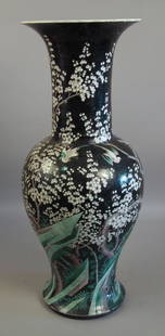 A Chinese “Famille Noir” porcelain and Yen-Yen vase bol: A Chinese “Famille Noir” porcelain and Yen-Yen vase boldly decorated with a prunus blossom and birds with mottled black glaze, 27ins (686mm) high (19th Century - rim with fritting, chips, cracked