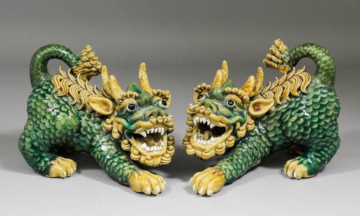 A pair of Chinese pottery models of crouching Dogs of F: A pair of Chinese pottery models of crouching Dogs of Fo, each 6.5ins (165mm) high (square seal marks)
