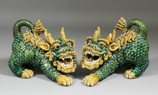 A pair of Chinese pottery models of crouching Dogs of F: A pair of Chinese pottery models of crouching Dogs of Fo, each 6.5ins (165mm) high (square seal marks)