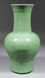 A Chinese celadon glazed pottery baluster shaped vase, : A Chinese celadon glazed pottery baluster shaped vase, 13ins (330mm) high (Qing Dynasty - 18th Century - neck ground down and chipped)