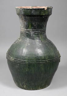 A Chinese green glazed bulbous vase with moulded handle: A Chinese green glazed bulbous vase with moulded handles and reeded bands, 12.25ins (311mm) high (Han Dynasty - flake chips to rim)