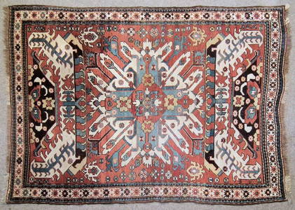 A Caucasian rug woven in primary colours with star shap