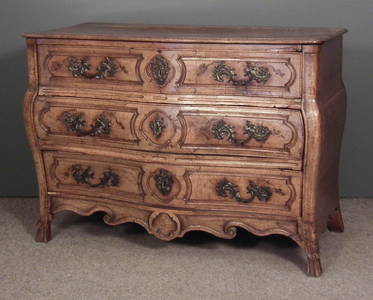 An 18th Century French fruitwood serpentine fronted com