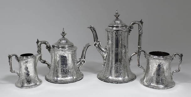 An early Victorian silver four piece tea and coffee: An early Victorian silver four piece tea and coffee service, the flared cylindrical bodies with bead mounts, the domed covers with turned finials, and the whole engraved with bold leaf scrolls,