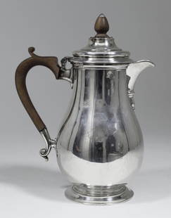 A Victorian silver baluster shaped hot water pot with: A Victorian silver baluster shaped hot water pot with turned wood handle and finial, 9.75ins high, by Mappin & Webb, London 1871 (gross weight 26ozs - engraved with crest)