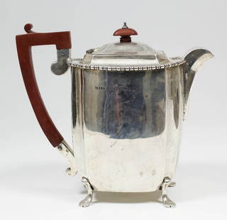 A George V silver hot water pot, the plain body with: A George V silver hot water pot, the plain body with concave corners and with gadrooned rim, on splayed feet, 7.5ins high, by J.W. Benson Ltd, London 1935 (gross weight 22ozs)