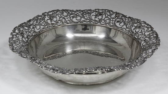 A modern American silvery metal circular fruit bowl: A modern American silvery metal circular fruit bowl with pierced and scroll cast rim, 12ins diameter x 2.75ins high, by Blackstar & Frost (stamped mark and 925 - weight 25ozs)