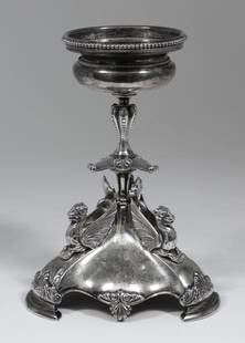 A late Victorian silver circular table centre with bead: A late Victorian silver circular table centre with bead mounts, with lobed knop to stem and on triangular base cast with three griffin, leaf and shell ornament, 3.75ins diameter x 8.25ins high, by