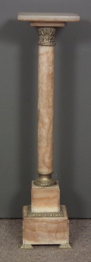 A late 19th/early 20th Century French brass mounted: A late 19th/early 20th Century French brass mounted cream veined alabaster square pedestal with plain cylindrical column and stepped square base, 10ins square x 39ins high (some chipping to top)
