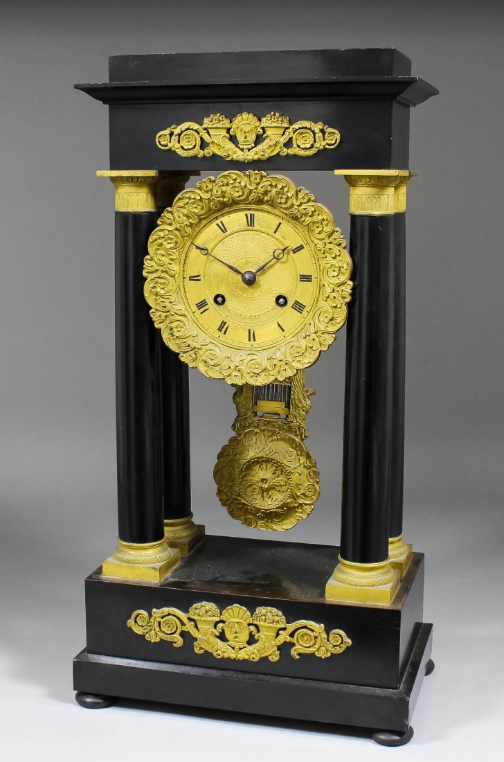 An early 19th Century French ebonised and ormolu: An early 19th Century French ebonised and ormolu mounted "Portico" mantel clock by Font Anil, Rue St. Martin, No. 158, Paris, the 4ins diameter gilt dial with Roman numerals, to the eight day two trai