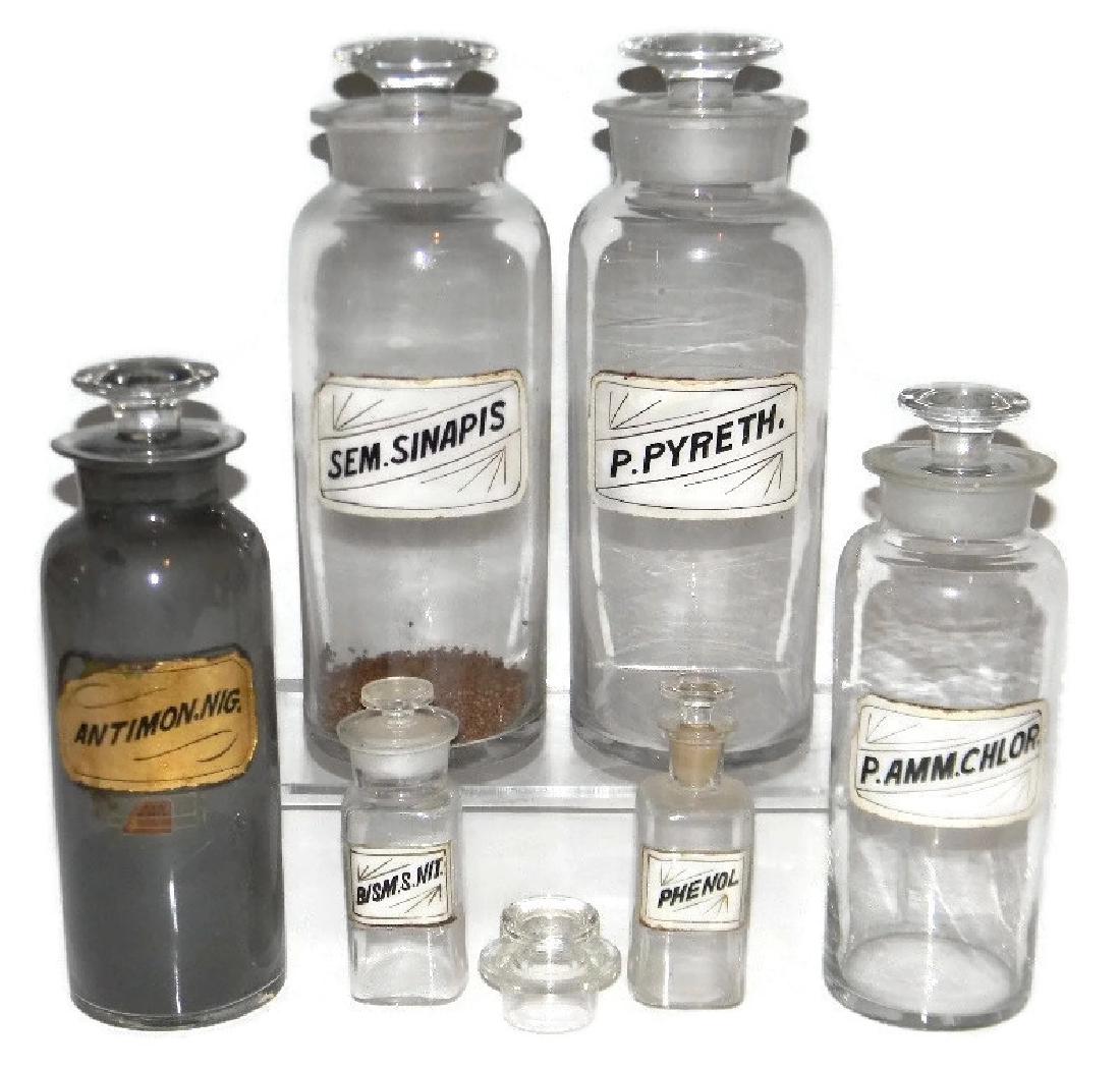 7 GLASS APOTHECARY DRUG JARS w/ LABELS UNDER GLASS: 7 GLASS APOTHECARY, PHARMACY AND DRUG JARS W/ LABELS UNDER GLASS: 7 total, largest four with labels under glass, these include P. Pyreth 12.25"h, Sem. Sinapis, 12.25"h (contents included); Antimony, 1
