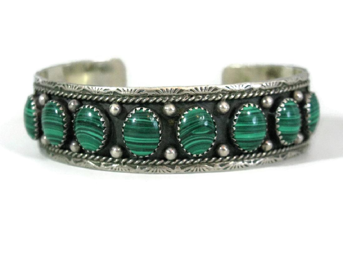 NAVAJO .925 CUFF BRACELET W/ MALACHITE ROGER SKEET: NAVAJO .925 CUFF BRACELET W/ MALACHITE ROGER SKEET: Vintage 20th c, Navajo, Native American. Cuff bracelet by Roger Skeet with 8 malachite cabochons (10x8mm) in saw-tooth mounts surrounded by applied 