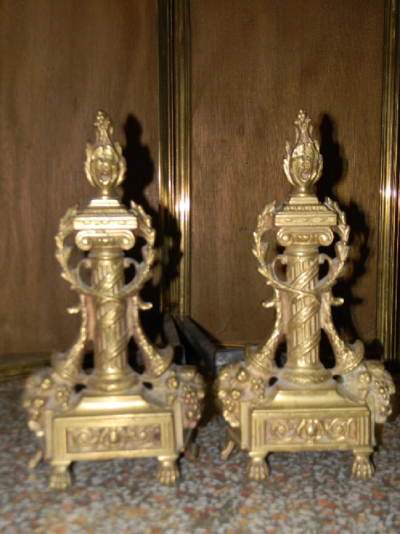 COLUMN & GARLAND FIREPLACE ANDIRONS / CHENETS: FRENCH COLUMN & GARLAND FIREPLACE ANDIRONS CHENETS: Each with the image of a classical column surrounded by a fruit filled cornucopia and laurel garlands, 13.5"h. Offered with a folding four panel bra