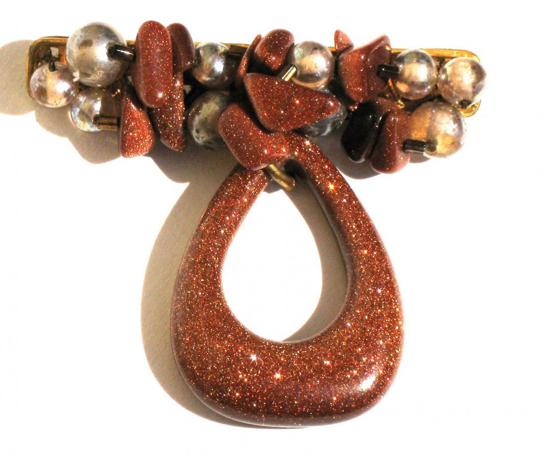 Miriam Haskell Goldstone Brooch Pin: Vintage Miriam Haskell Brooch with large triangular goldstone pendant drop connected to a gold tone bar pin encrusted with gold tone and glass faux pearl beads. This piece is stamped Miriam Haskell on