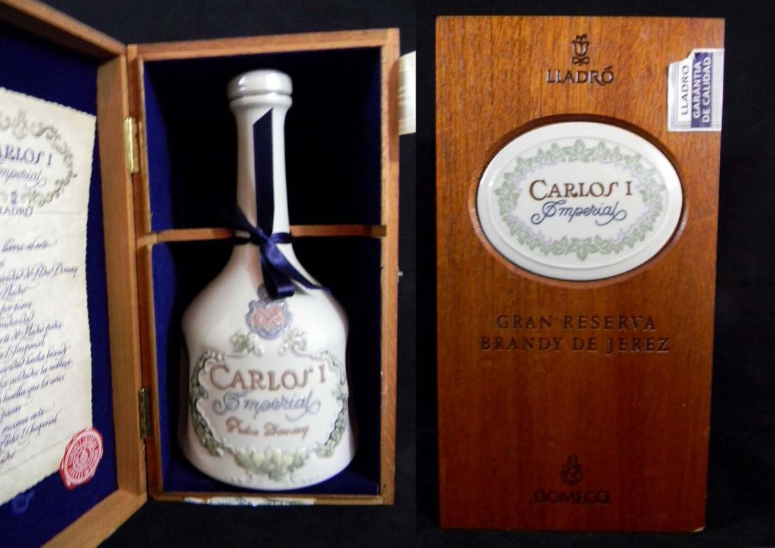 Lladro Carlos I Brandy Decanter Unopened Original Box: This unopened, numbered porcelain decanter of brandy was made by Lladro for Carlos I Imperial. It is housed in the original wood box with certificate. Designed 1985 for Pedro Domecq in 1985. This is N