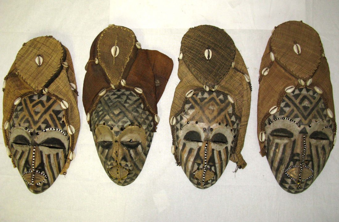 Set of Four African Ngaady Masks Wood Masks: Set of Four African Wood and Bead Ngaady A Mwaash masks, made from carved wood, natural pigment beads and cowrie shells