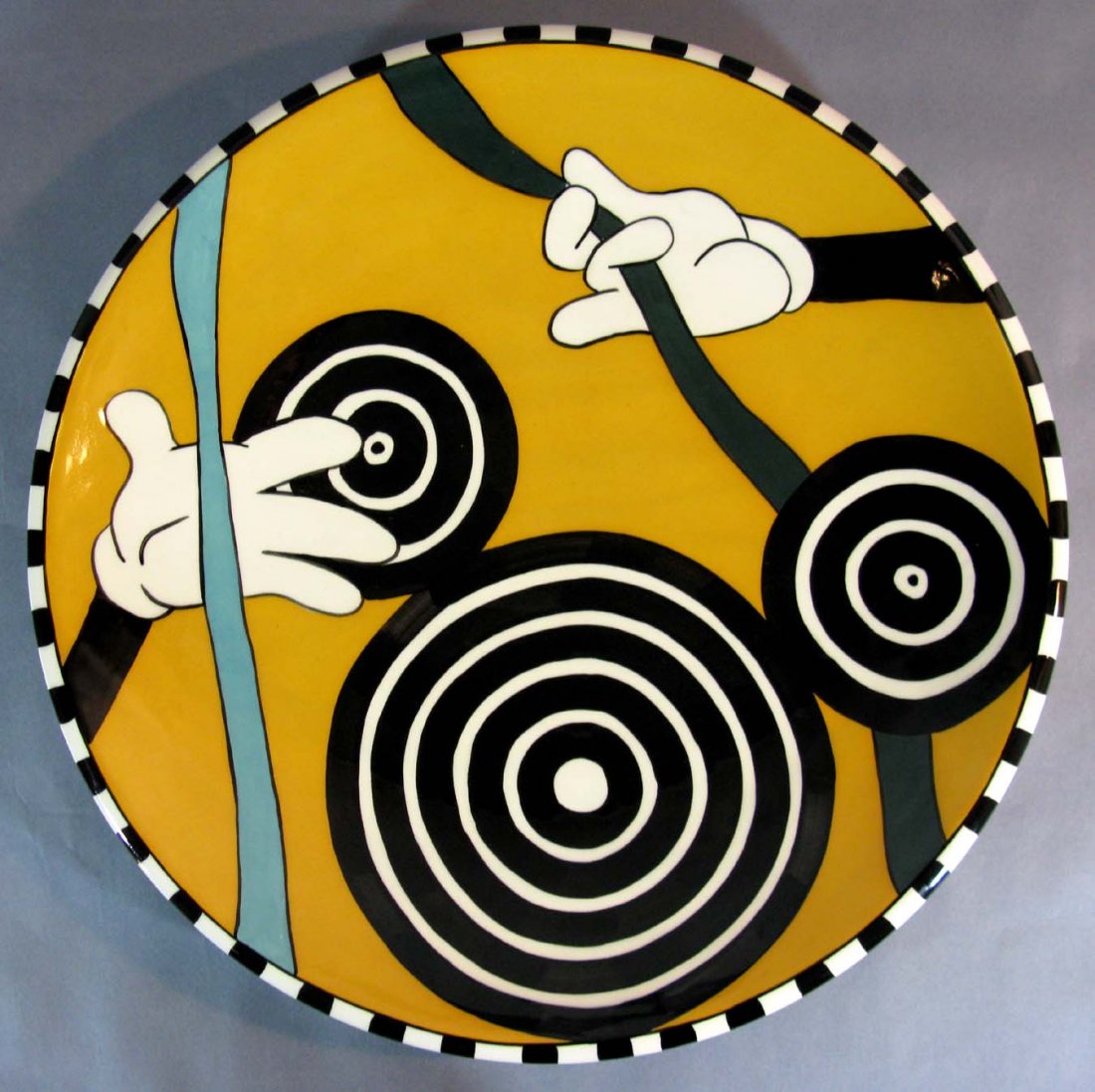 Bull's Eye Mickey Ceramic Disney Fine Art Charger Lee: Bull's Eye Mickey ceramic, hand-painted charger. Contemporary, hand painted piece is a rare variation with an orange background (most are on blue). The design features a Mickey Mouse head in concentri