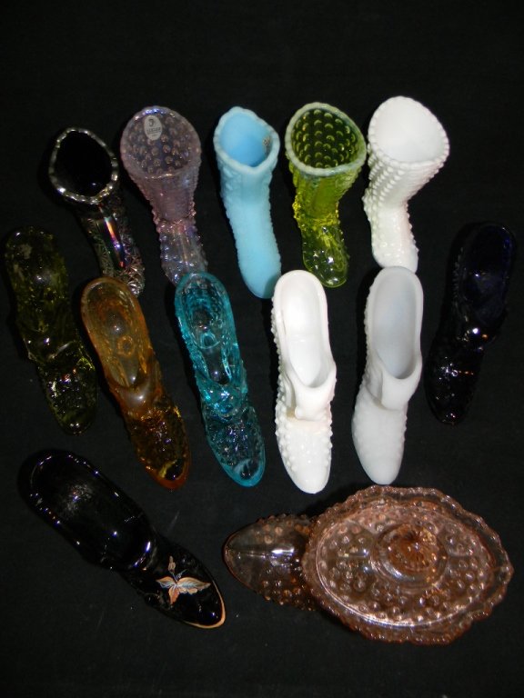 12 Fenton Glass Shoes and Boots: 11 Fenton Glass Shoes and boots, varying patterns include: 1 Black Rose, hand pained shoe by J. K. Robin" Spindler; 6 @ Hobnail Slipper with Cat in green, orange cobalt and translucent blue, white mil
