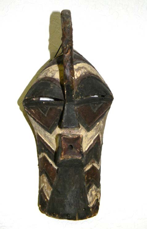 African Carved & Painted Mask Songye Kifwebe: African Carved & Painted Male Songye Kifwebe Mask, Democratic Republic of the Congo. Stylized form with angular nose and mouth decorated with pigment ( 7 L x 9" W x 15" H) Condition: Repair to front o
