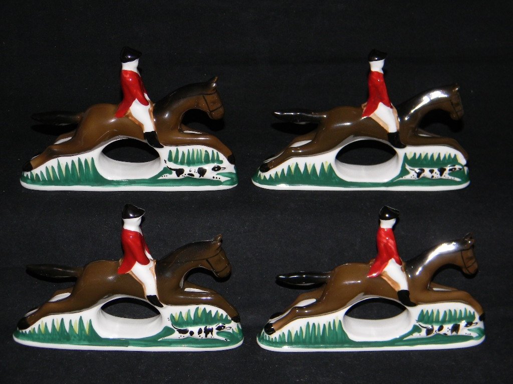 4 BONE CHINA EQUESTRAIN FOX HUNT NAPKIN RINGS: 4 Bone China Equestrian Fox Hunt Napkin Rings, each depicting a Master of the Hunt on horseback with spotted dog running beside, each measures 4h x 5 3/4"l; PIA Philippines, Bone China. Condition: Fre