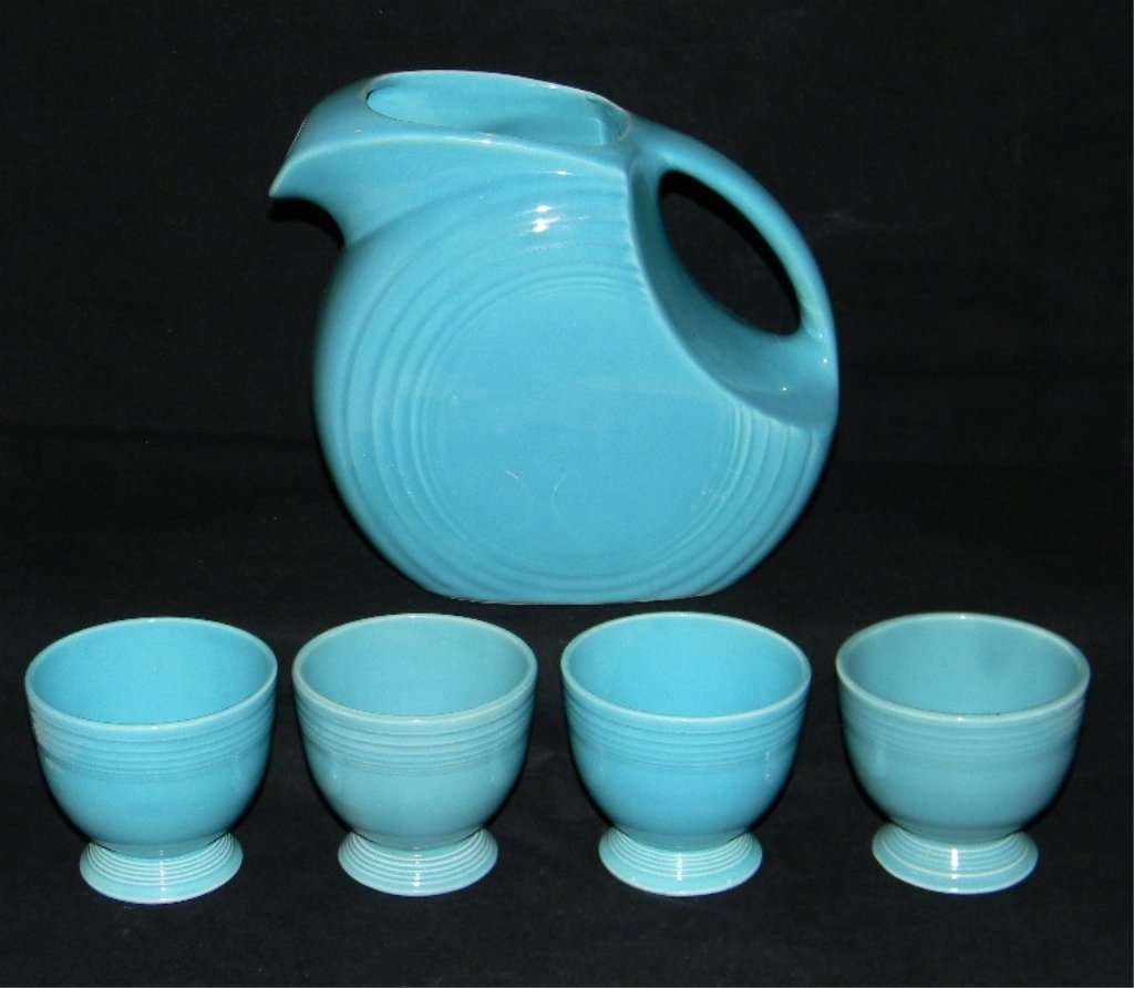TURQUOISE FIESTAWARE DISC PITCHER & 4 EGG CUPS: TURQUOISE FIESTAWARE DISC PITCHER & 4 EGG CUPS; pitcher 7 1/2h; egg cups 3 1/8"h. Condition: All free from chips, cracks and restoration.