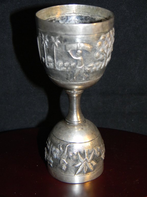 COLONIAL INDIA SILVER REPOUSSE DRINKING VESSEL: ANTIQUE COLONIAL INDIA REPOUSSE DOUBLE ENDED DRINKING VESSEL/ Egg Cup; Probably from Lucknow, deeply decorated with repousse decoration of a pastoral scene with people and trees surrounding a central 