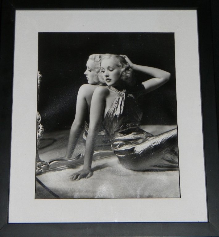 GEORGE HURRELL STAMPED PHOTO OF BETTY GRABLE: GEORGE HURRELL STAMPED PHOTO OF BETTY GRABLE: With Hurrell's stamp on back, visible through the cut acid free mat and graphite signature of the printer. Framed: 13 1/4" H x 11 3/4" W. George Hurrell P