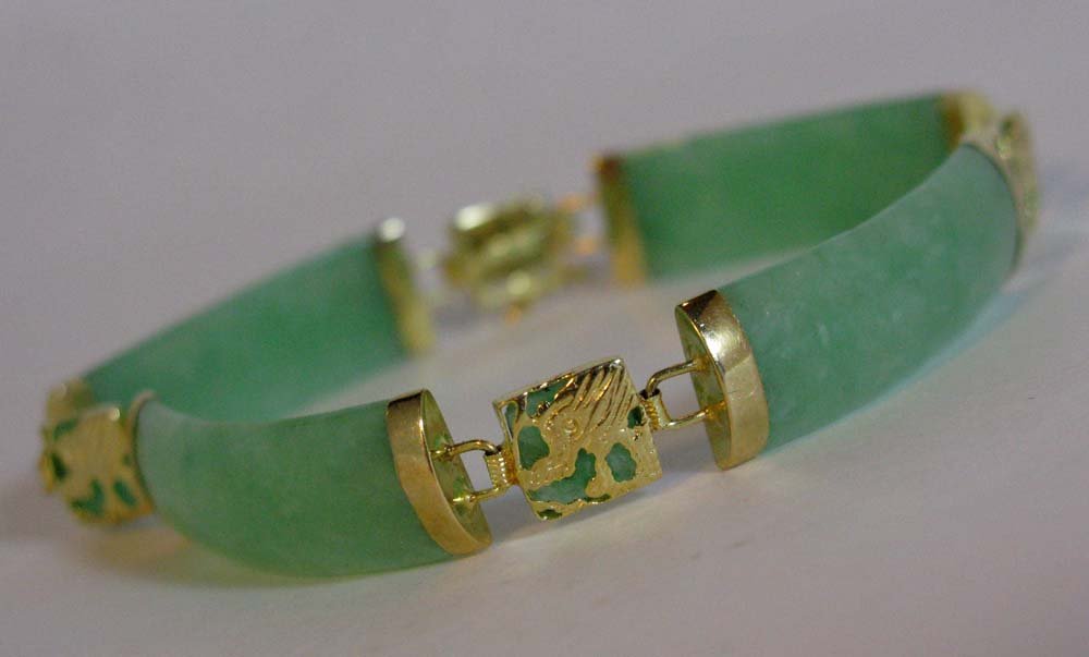 14K YELLOW GOLD AND JADE OR JADEITE BRACELET I: 14K YELLOW GOLD AND JADE OR JADEITE BRACELET: Stamped 14k 585 Gold and jade or jadeite; deign alternates 4 oblong, curved green jade links with 14K gold over jade or jadeite squares with dragon head l