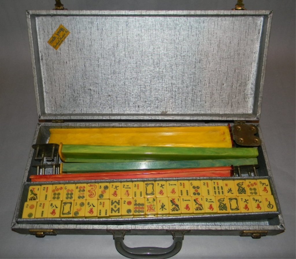 VINTAGE CATALIAN MAH JONGG SET; CARDINAL, c. 1950: VINTAGE CATALIAN MAH JONGG SET BY CARDINAL: . Vintage Mah Jongg set, by Cardinal Industries, NY, complete with five colorful trays ending in metal fitted rests, 152 tiles and one score piece; Exterior
