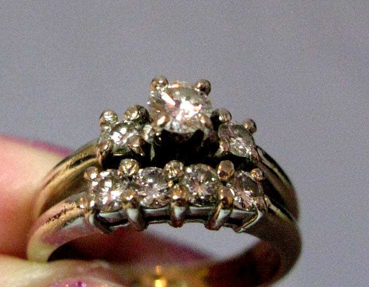 14K GOLD AND DIAMOND RING: 14K GOLD AND DIAMOND RING: 7 stone setting in 14k gold, engagement and wedding bands fused together. Total weight: 5g; Central diamond approx. .2 carats; surrounding 6 diamonds approx. .05 carats each
