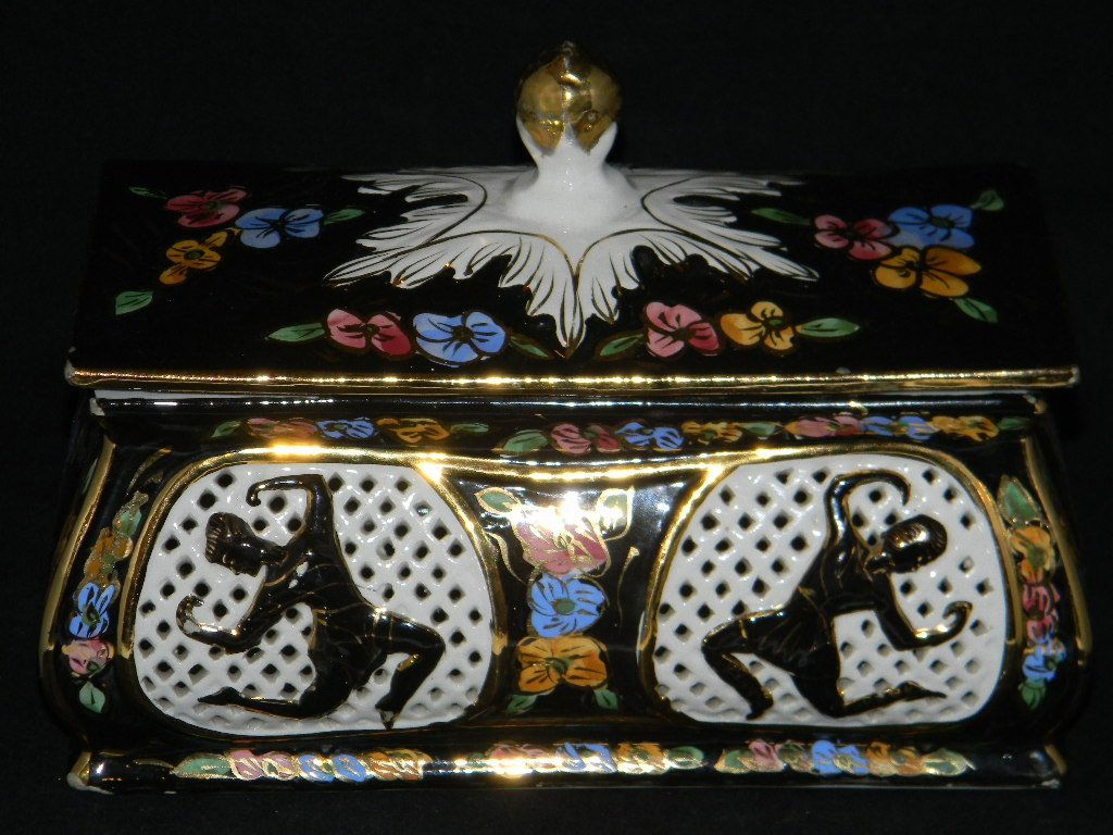 CAPODIMONTE POLYCHROME CASKET OR POTPOURRI: CAPODIMONTE POLYCHROME CASKET OR POTPOURRI: Reticulated with dancing figures in gilded black glaze, 5 3/4"h x 8"l x 4 1/2"d.