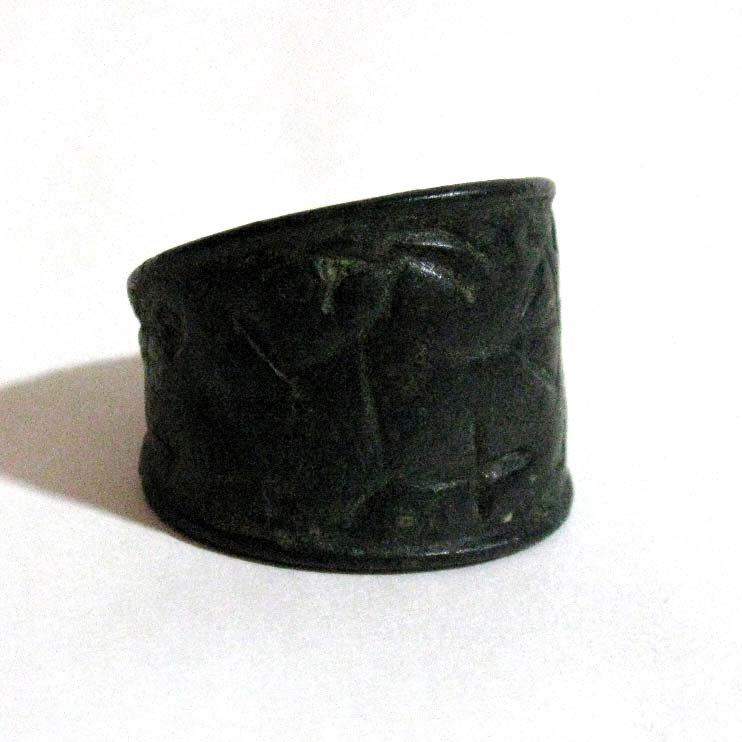 NEAR EAST BRONZE SEAL RING (A): NEAR EAST BRONZE SEAL RING: Thick and heavy ring with the image of a figure shooting a bow at a horned animal, Probably Syrian, Mesopotamia or Luristan, c. 2000 BC; Size 14 or 15, 29.55 g. PROVENANCE: