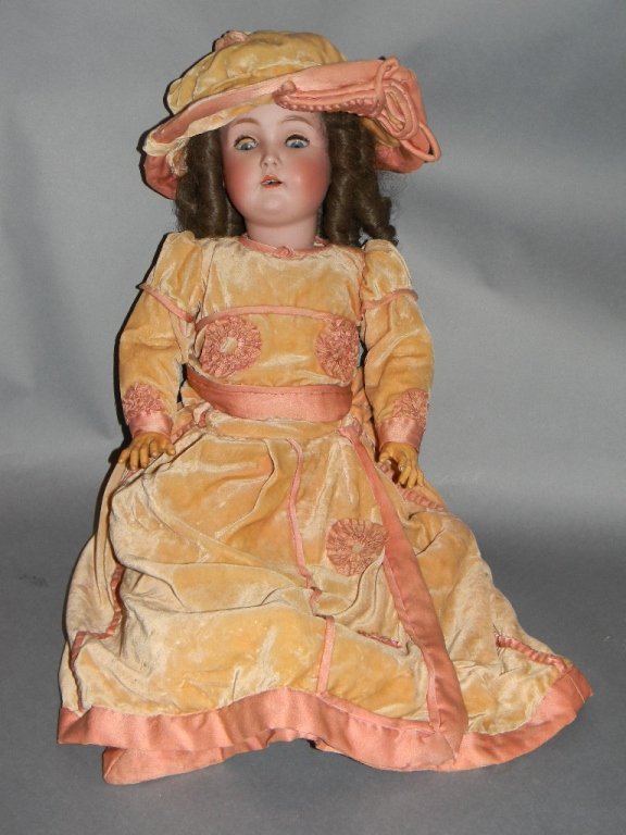25" KESTNER GERMAN BISQUE 171 DOLL W/ VELVET DRESS: J.D. Kestner, Jr. bisque socket head doll, circa 1900, having painted facial features, blue sleep eyes, open mouth showing four teeth, on a ball jointed composition body appropriately dressed; Marked 