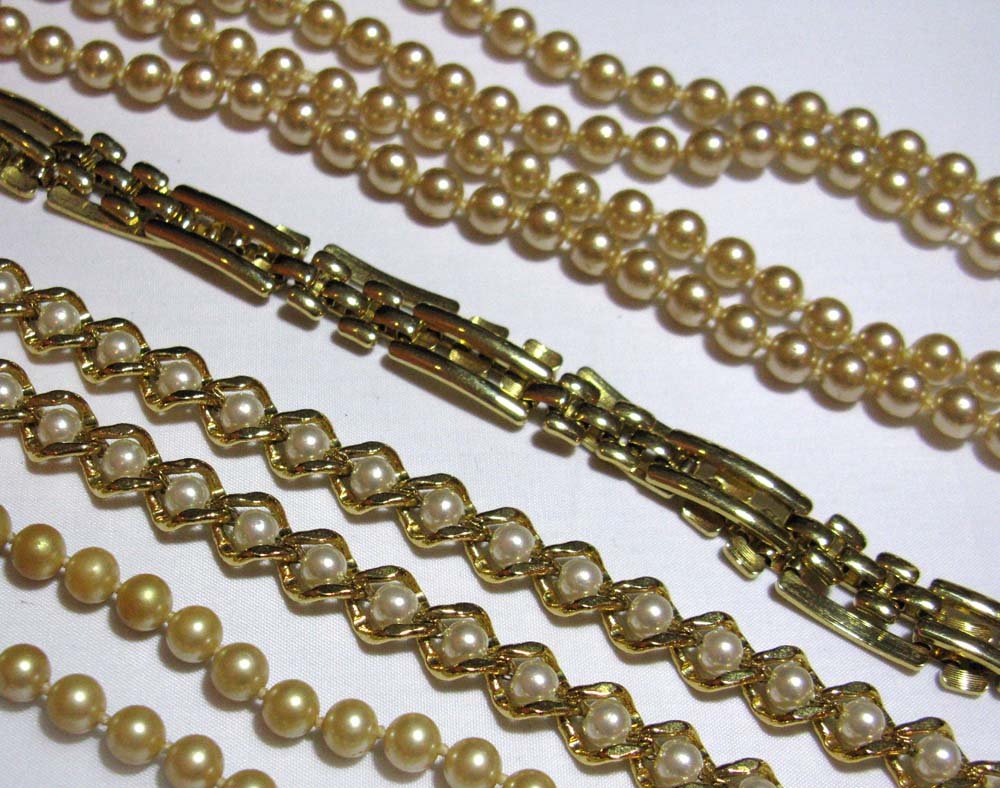 COLLECTION OF SIGNED COSTUME JEWELRY: COLLECTION OF SIGNED COSTUME JEWELRY: Monet Gold Tone Link Necklace, 16" l. Napier gold tone and faux pearl necklace, 16" l. To strands of faux knotted pearls 44" l and 16" l.