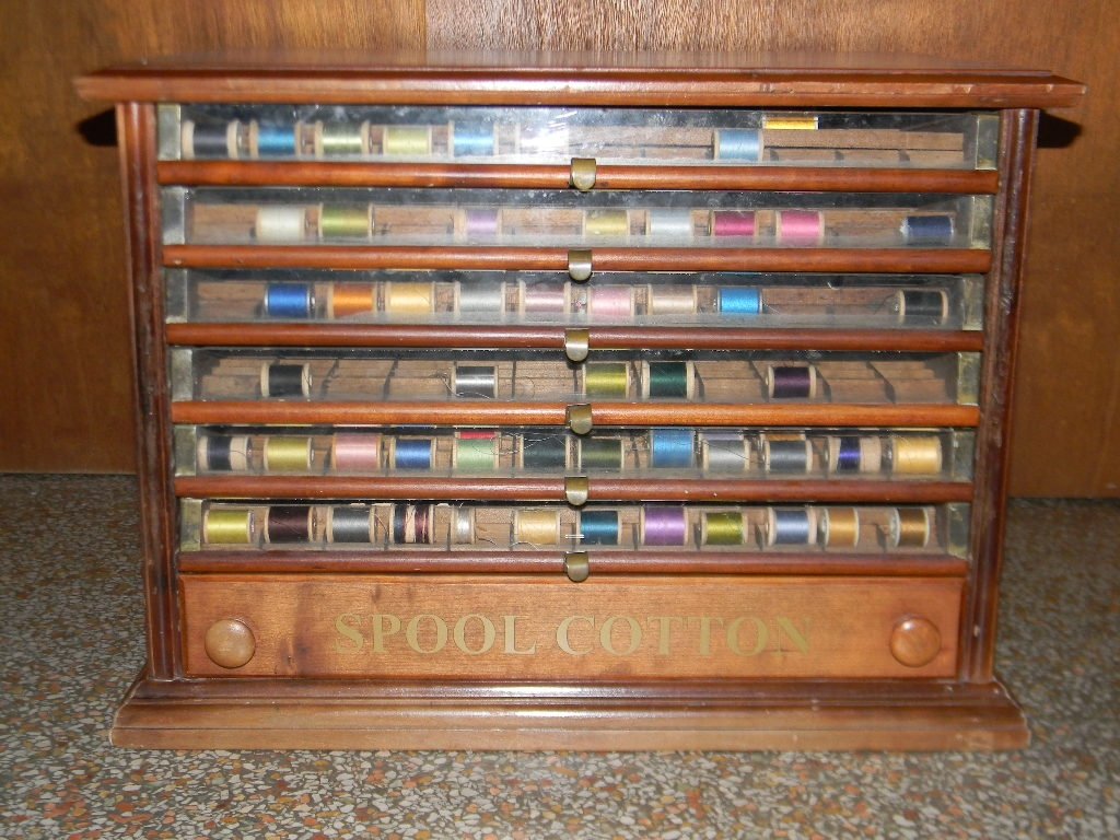 C. 1900 GLASS FRONTED 6 DRAWER SPOOL CABNET: An antique wood and glass spool cabinet, comprised of 6 glass fronted drawers and a wood lower drawer, all with the original inserts and metal hardware. 32"l x 16.25"w x 16.25"h.