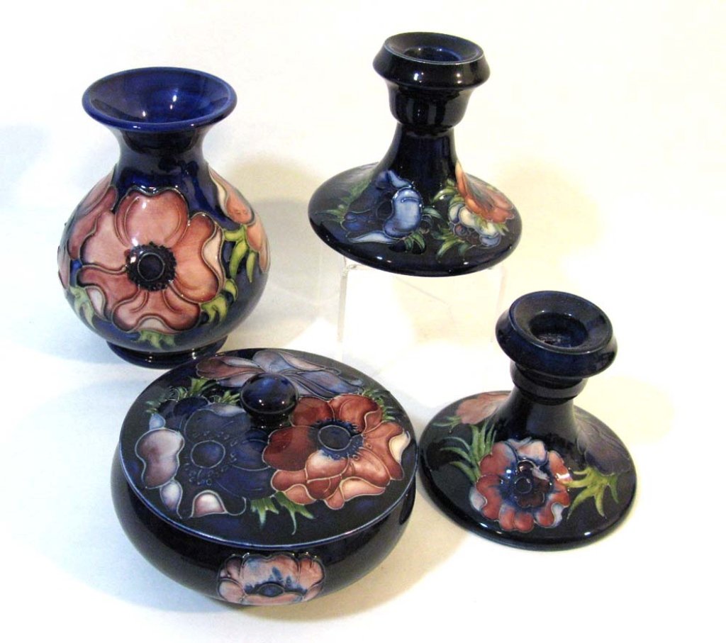 4 MOORCROFT POPPY Candle Sticks, Vase, Lidded Bowl: Collection of four, vintage Moorcroft ceramic vessels in the tube-lined "Poppy" pattern on a rich cobalt blue ground; most with the original paper label to base and Moorcroft impressed maker's marks.