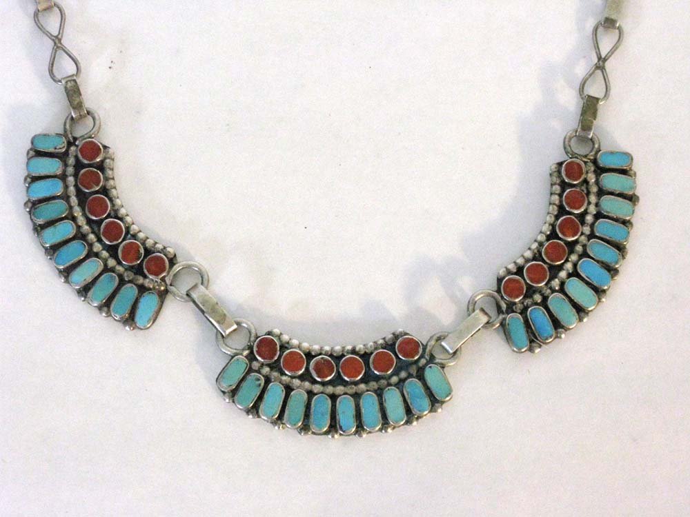 VINTAGE NATIVE AMERICAN STERLING NECKLACE: Stunning Native American sterling necklace mounted with turquoise and red coral. Three sterling links each with flush mounted stones which are attached to hand-made sterling links, 16"l. Weight: 9.66g