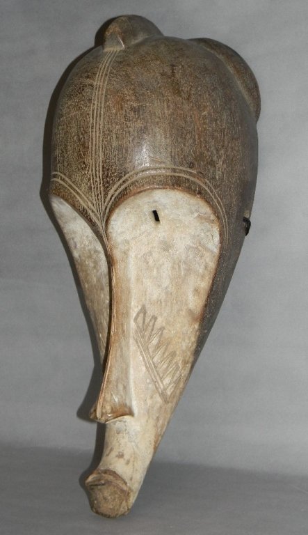 AFRICAN CARVED WOOD MASK FANG GABON: African, tribal carved and painted wood mask, Fang tribe, Gabon, Ngil mask, sensitively carved with heart shaped brows, dish shaped face and strong, protruding chin and mouth. Ritualistic scarificatio