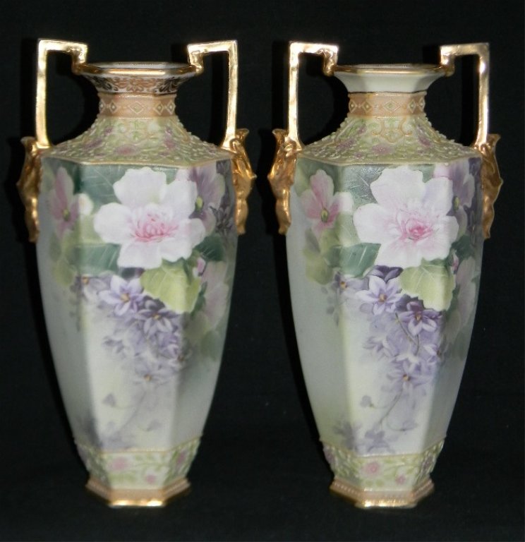 PAIR OF HAND PAINTED JAPANESE NIPPON VASES 10.75"h: A matched pair of hand-painted, Morimura, Nippon porcelain vases. Each with six sided body and heavily gilded double handles with masks. Each is naturalistically painted with flower blossoms and paste
