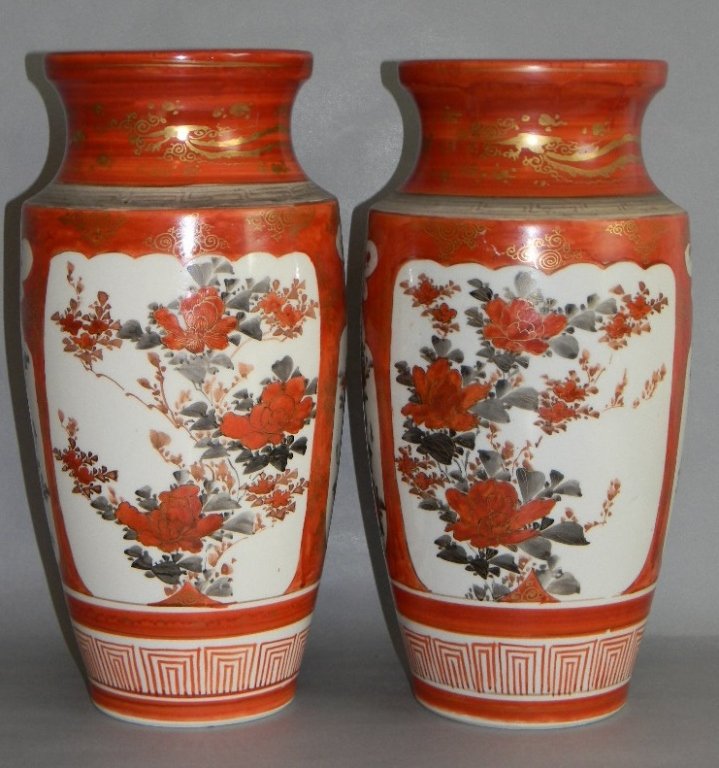 PAIR JAPANESE KUTANI PORCELAIN VASES 12.25: Matched pair of circa 1900, Japanese porcelain vases from Kutani. Each with white panels reserved on an iron-red ground gilded with stylized clouds. Reserves painted with gilded peony sprays; Kutani m