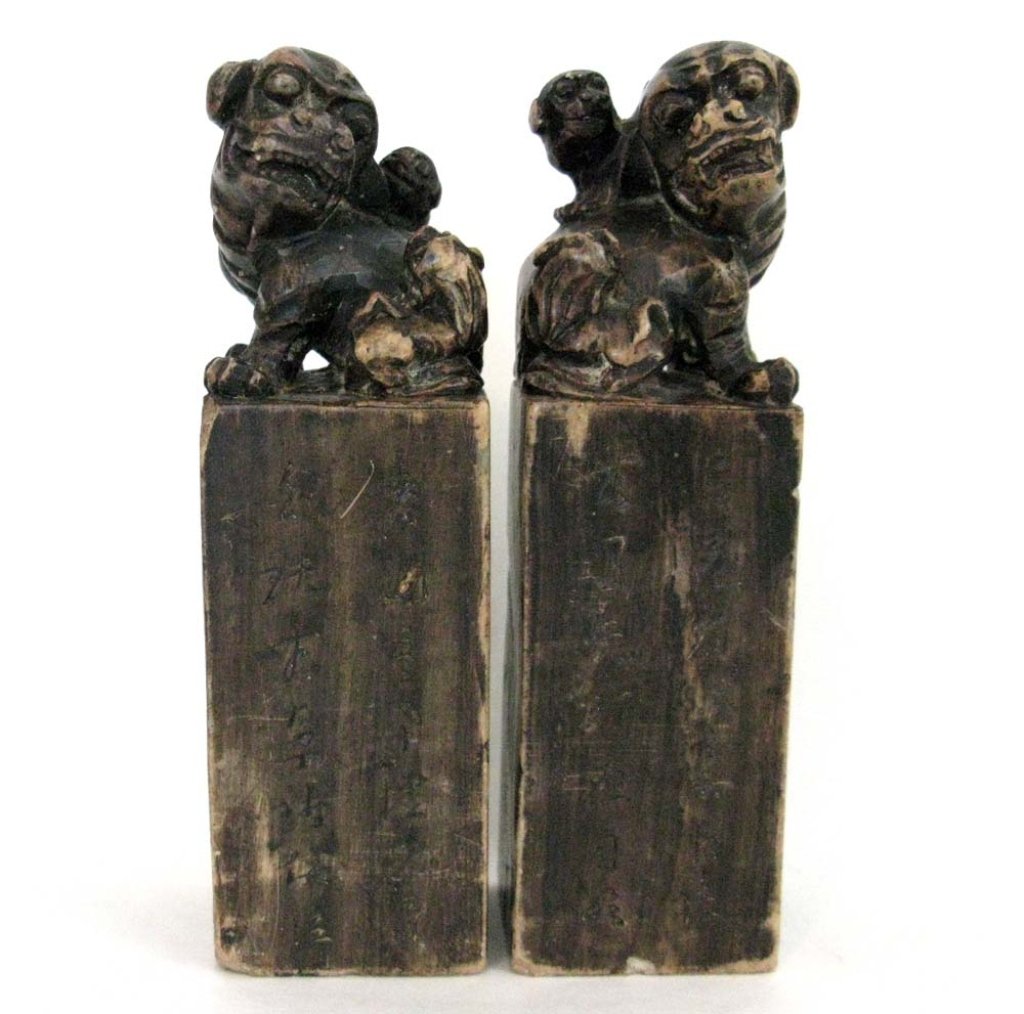 PAIR OF LARGE CHINESE STONE SEALS W/ FOO DOGS: Pair of antique, Chinese large carved stone seals each, each with grown foo dogs surrounded by pups, each carved with chop signatures on base and characters on front. each 7.5"h (19.05cm). PROVENANCE: