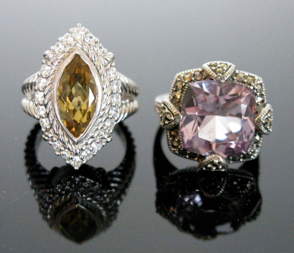 TWO STERLING & GEMSTONE RINGS: JUDITH RIPKA: Two Sterling silver and gemstone rings. To include: 1.) Judith Ripka sterling silver and gemstone ring with marquise cut Olive Quartz stone surrounded by round Diamoniques. Stamped, "JUDITH RIPKA 925